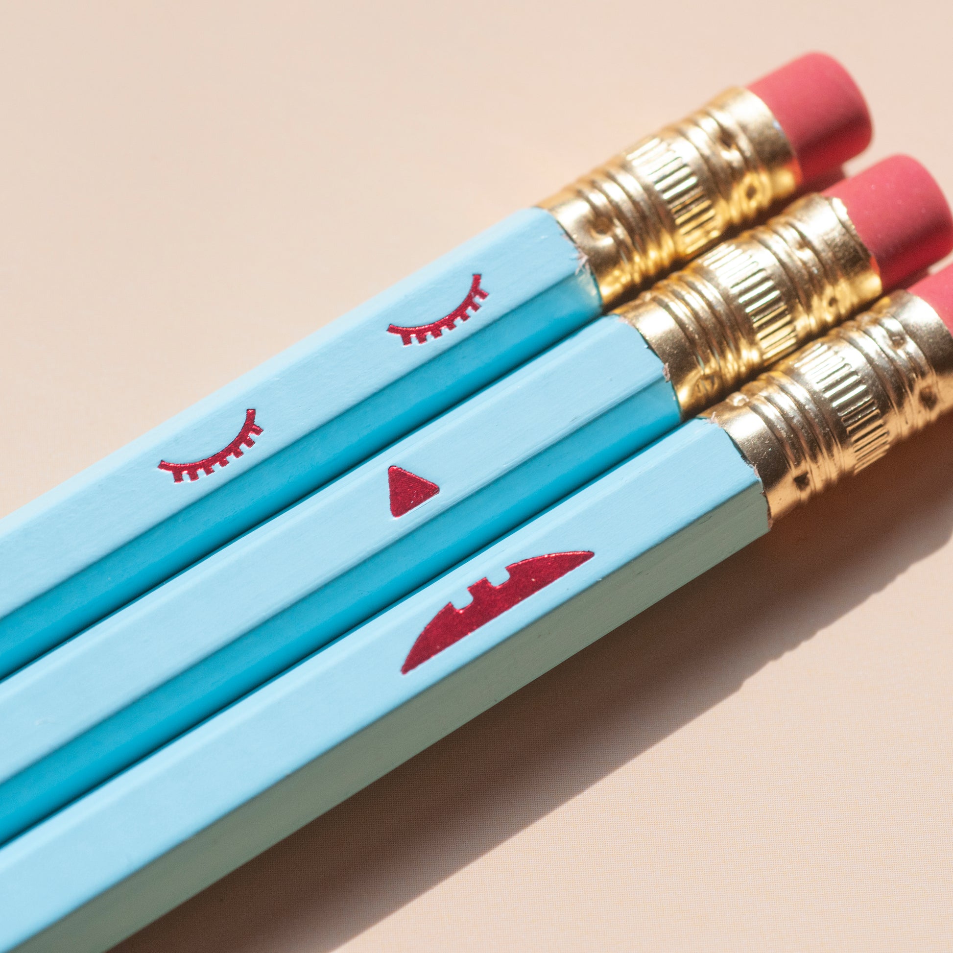 Macro sad face pencil set. Happy on the front and sad on the back. Hand-stamped using hot-foils on wooden hexagonal pencils