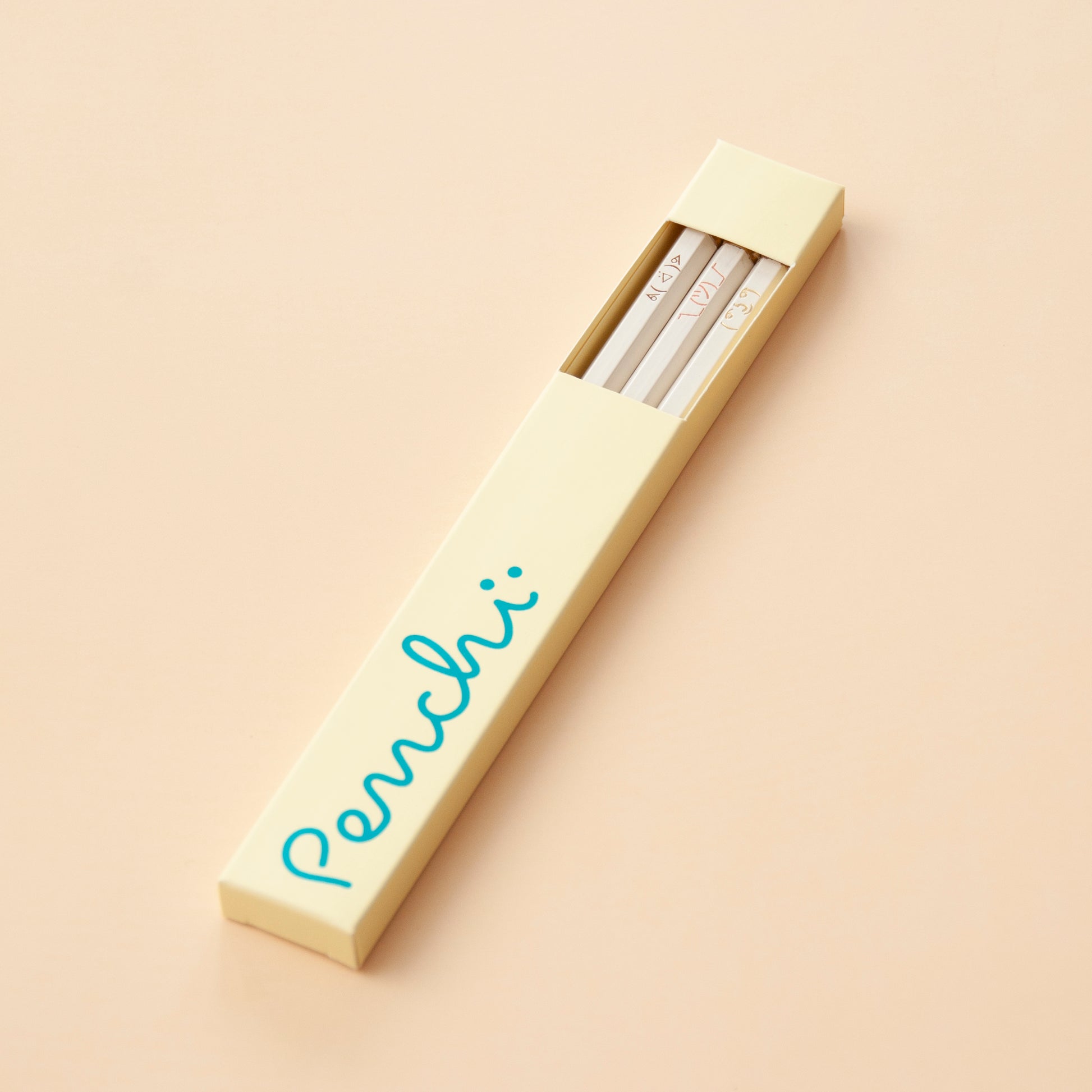 ASCII faces hand-stamped pencil set in box packaging with window, neutral shades