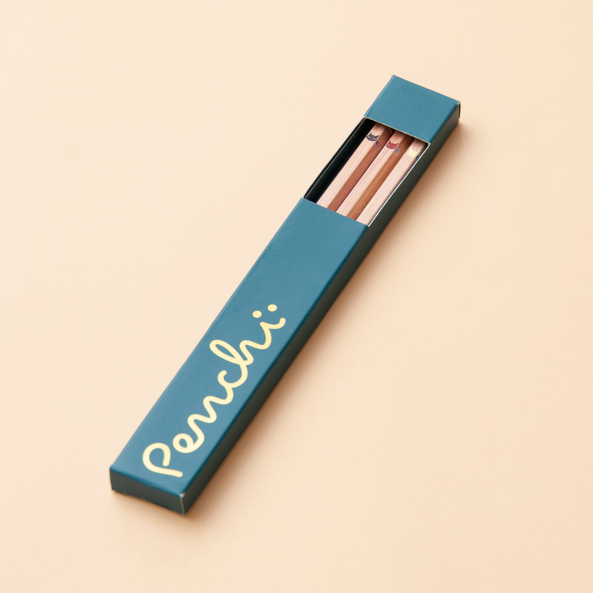 Natural wooden hexagonal pencils featuring cute kitten faces with whiskers, in pencil packaging box