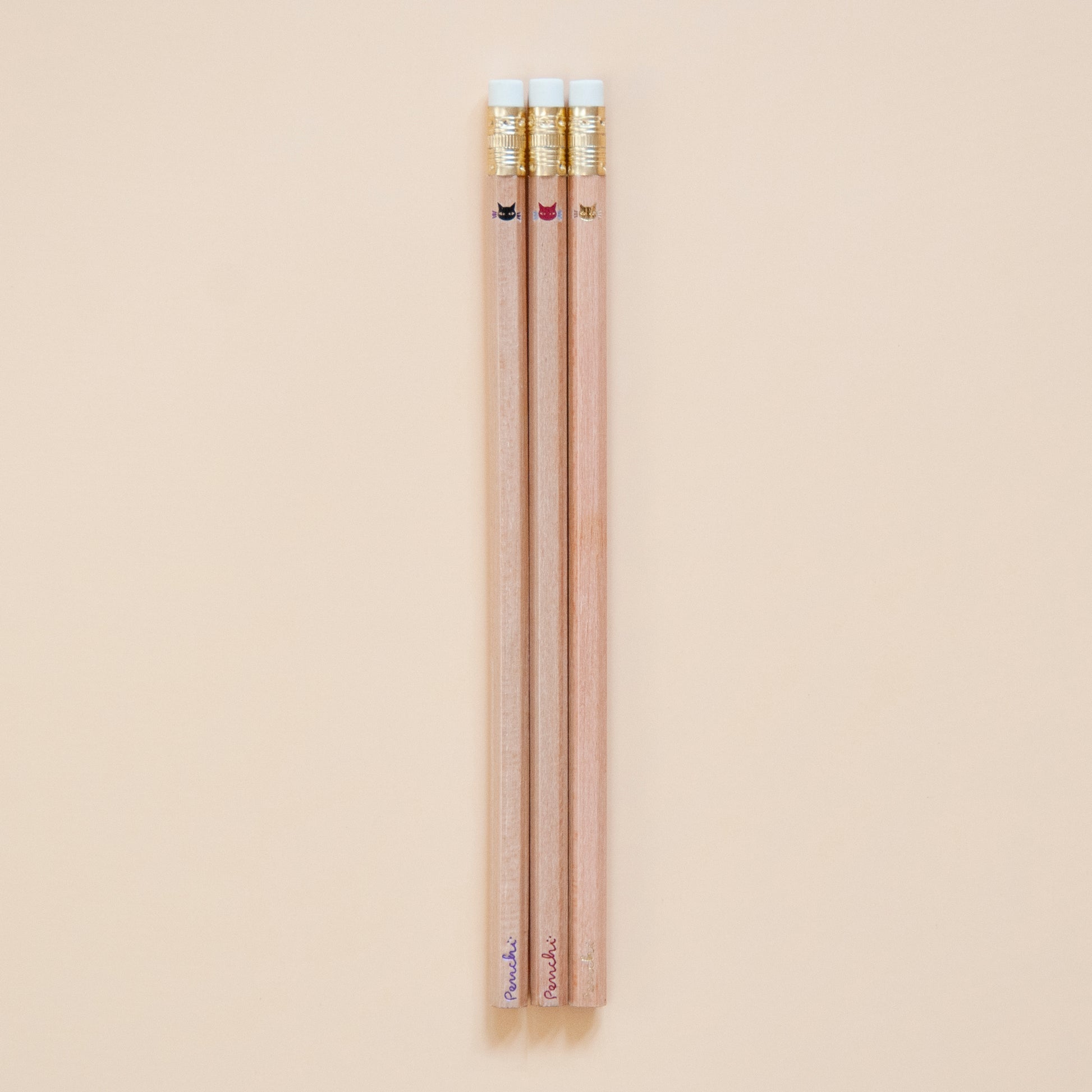 Cute tiny minimalist shiny metallic kitty cat faces, stamped by hand on natural wood pencils using hot metallic foils