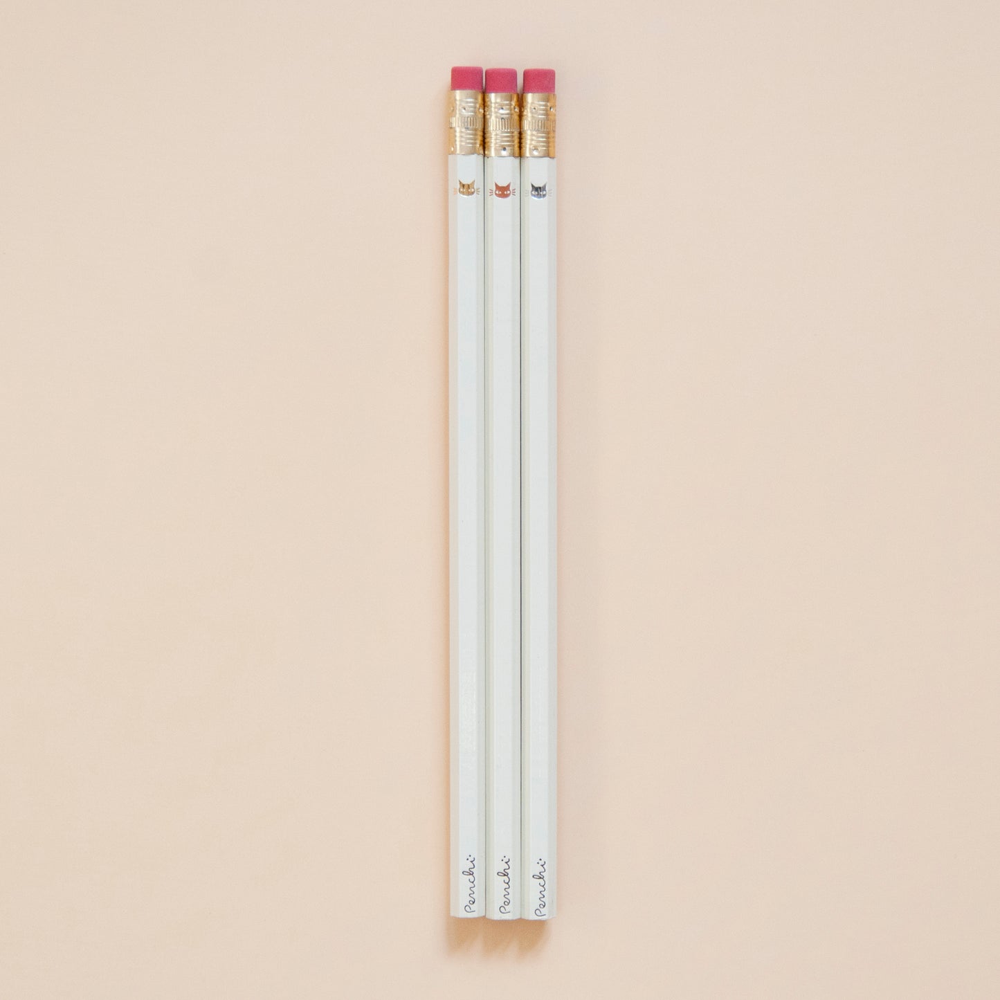 Cute tiny minimalist shiny metallic kitty cat faces, stamped by hand on ivory pencils using hot metallic foils, gold, copper, and silver