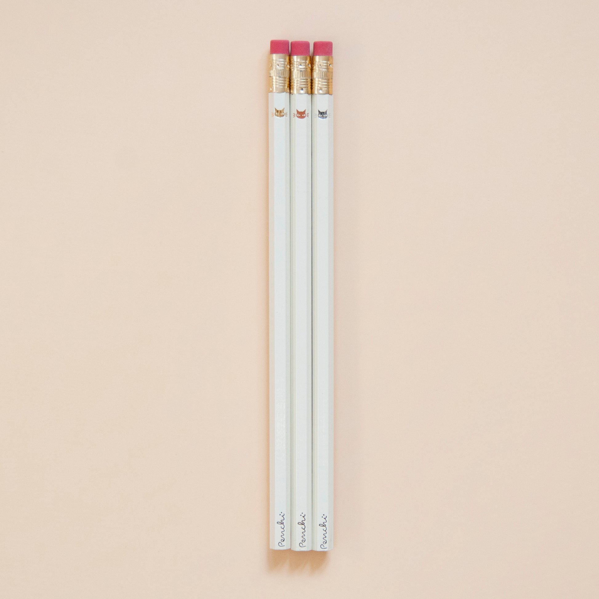 Cute tiny minimalist shiny metallic kitty cat faces, stamped by hand on ivory pencils using hot metallic foils, gold, copper, and silver