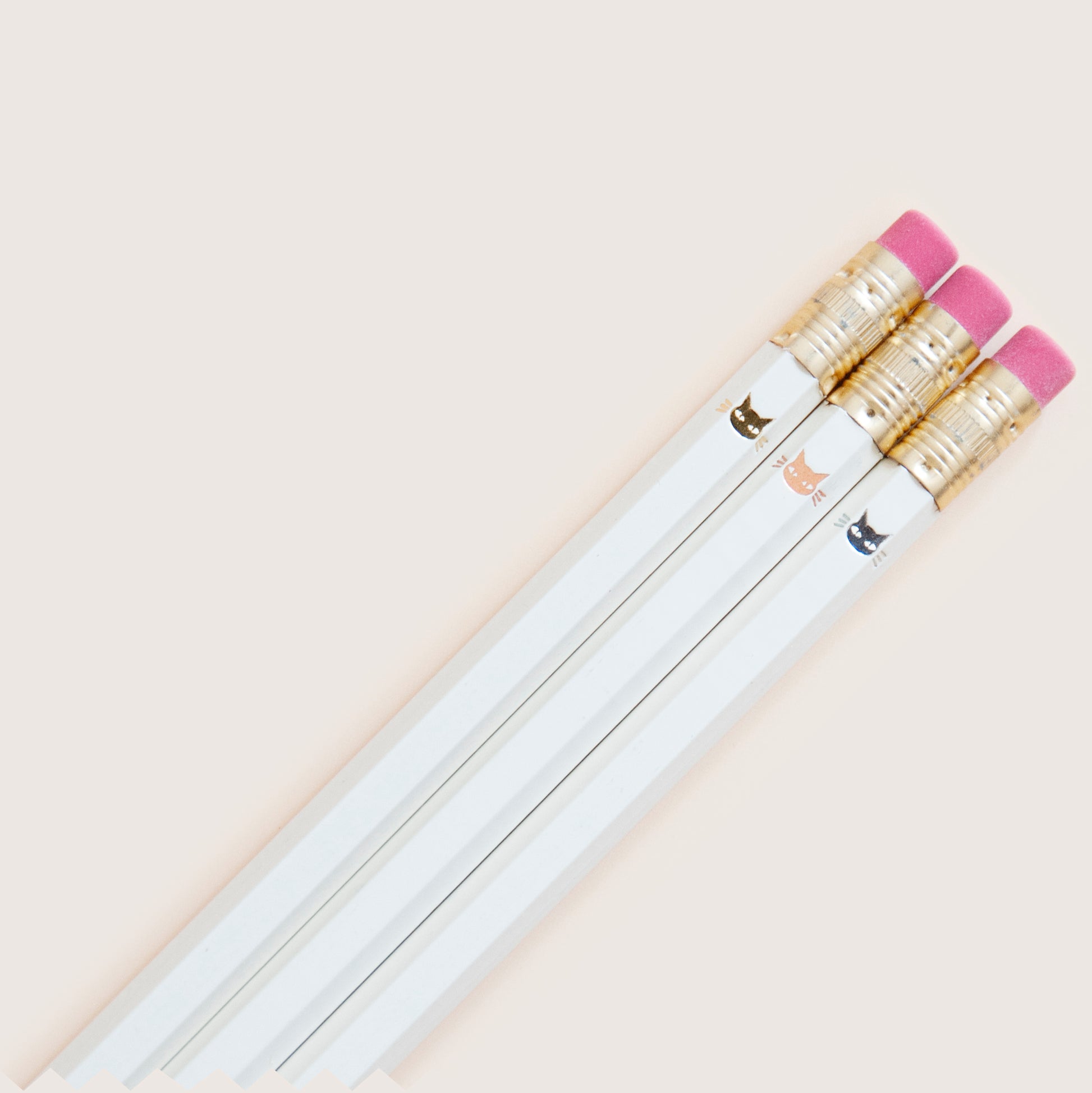 Cute tiny minimalist shiny metallic kitty cat faces, stamped by hand on ivory colored pencils using hot metallic foils