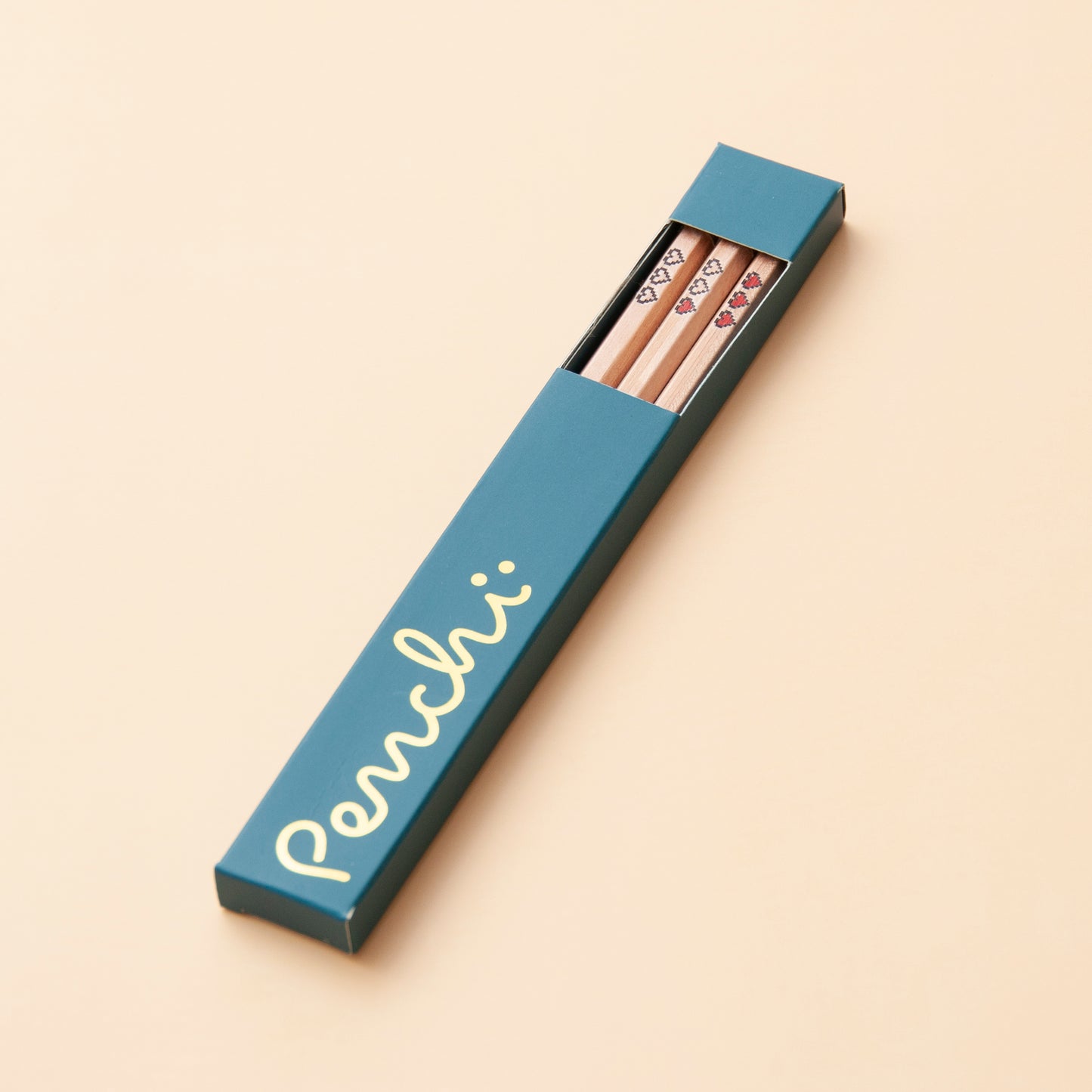 Handmade foil-stamped pencils with pixel hearts, packaged in box with window and gold foil