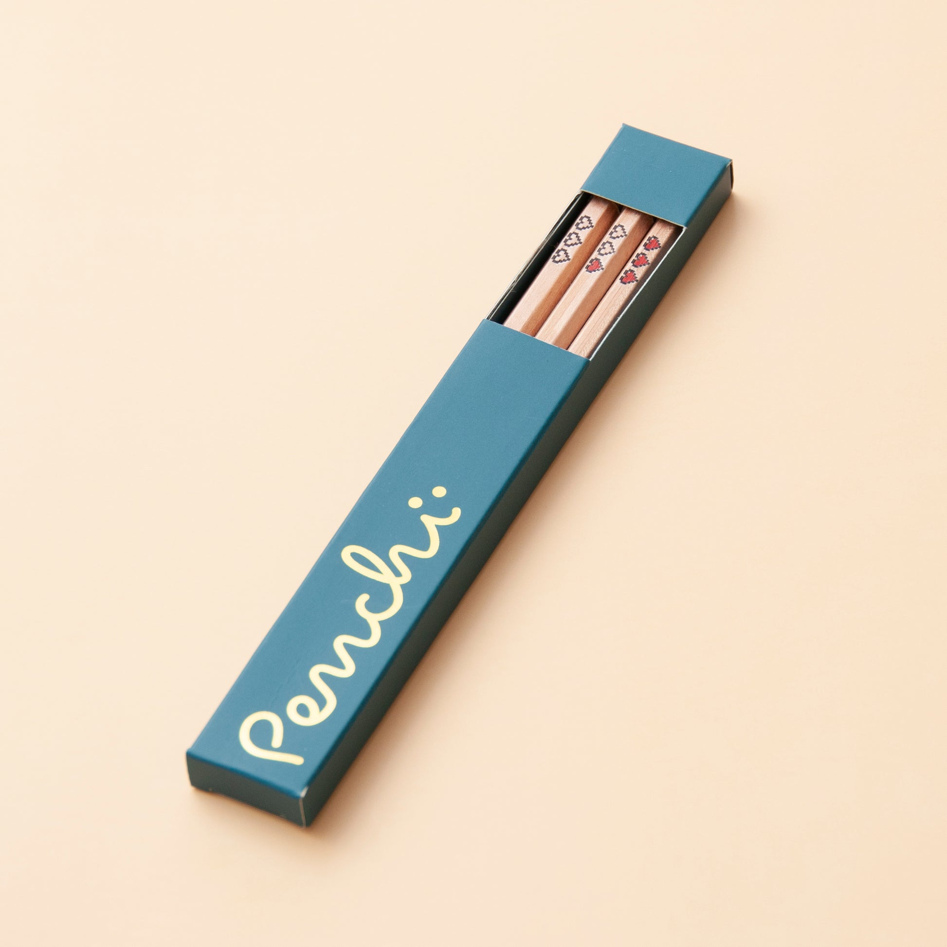 Handmade foil-stamped pencils with pixel hearts, packaged in box with window and gold foil