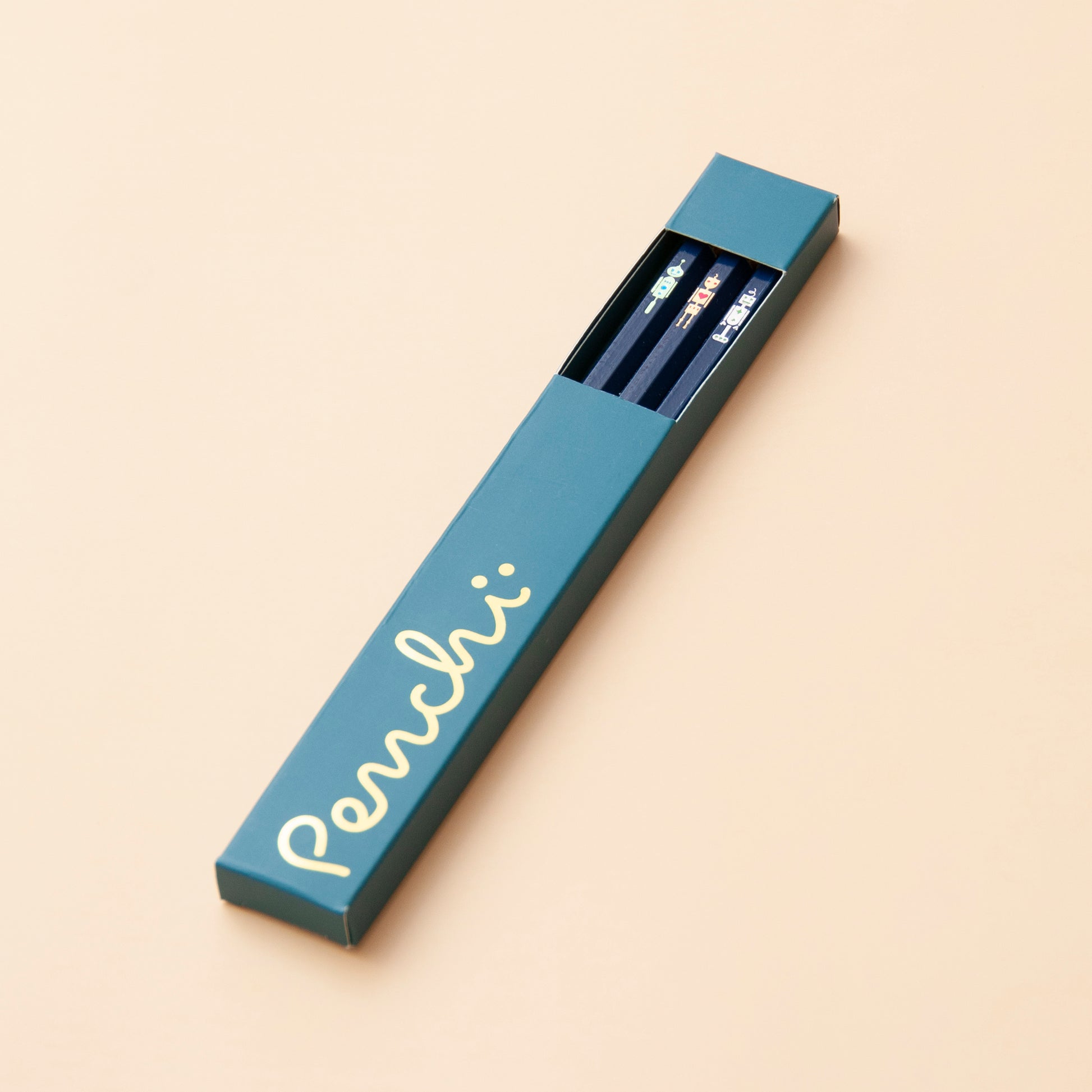 Pencil box packaging featuring a little window, holding the Penchi Robots pencil set inside, dark blue version