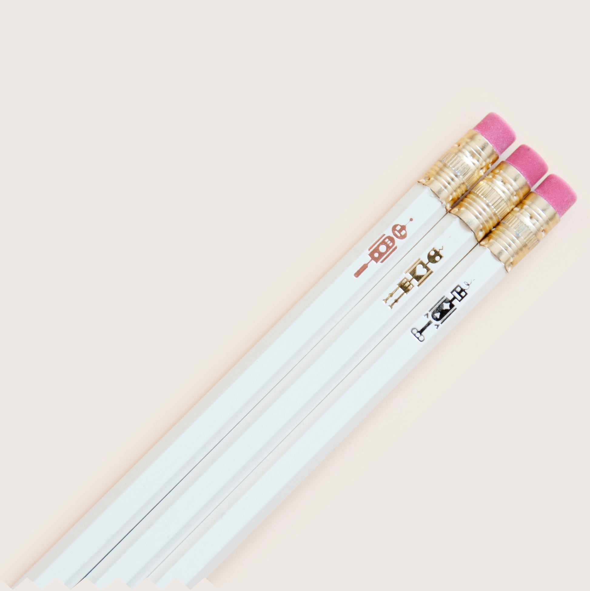 Shiny hand-stamped hot foil pencil set featuring 3 tiny little robots
