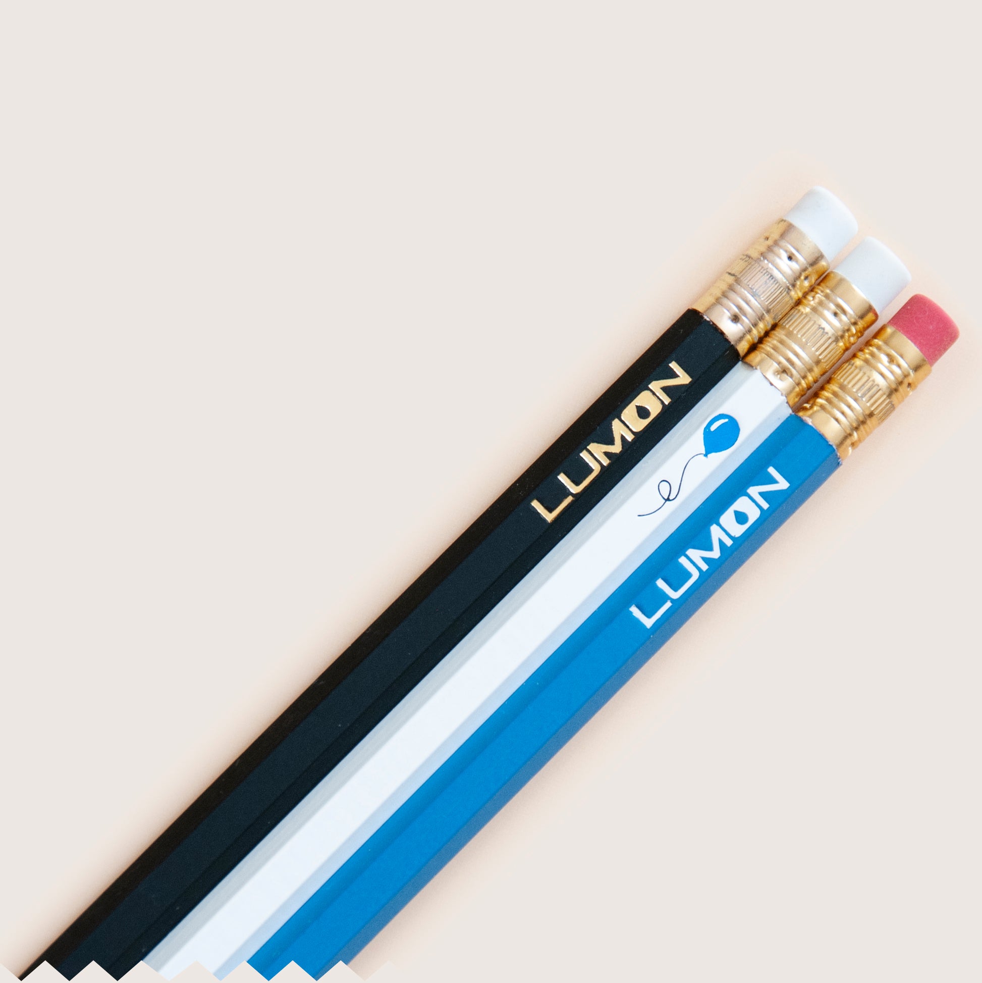 Severance Lumon logo pencil set, hot-stamped with metallic foils, black, white, and blue