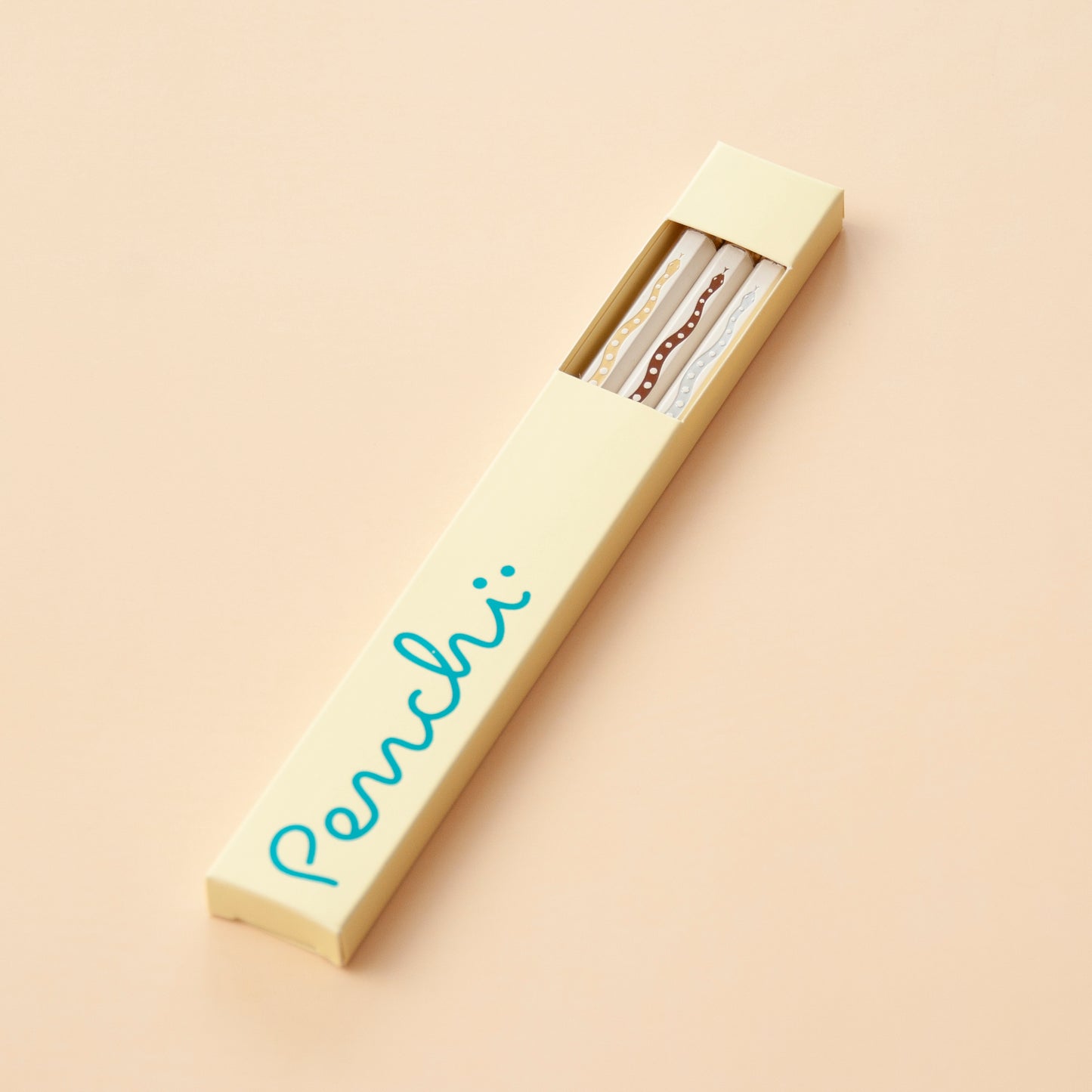 Hot-foil stamped snake pencil set in box packaging with window, neutral shades