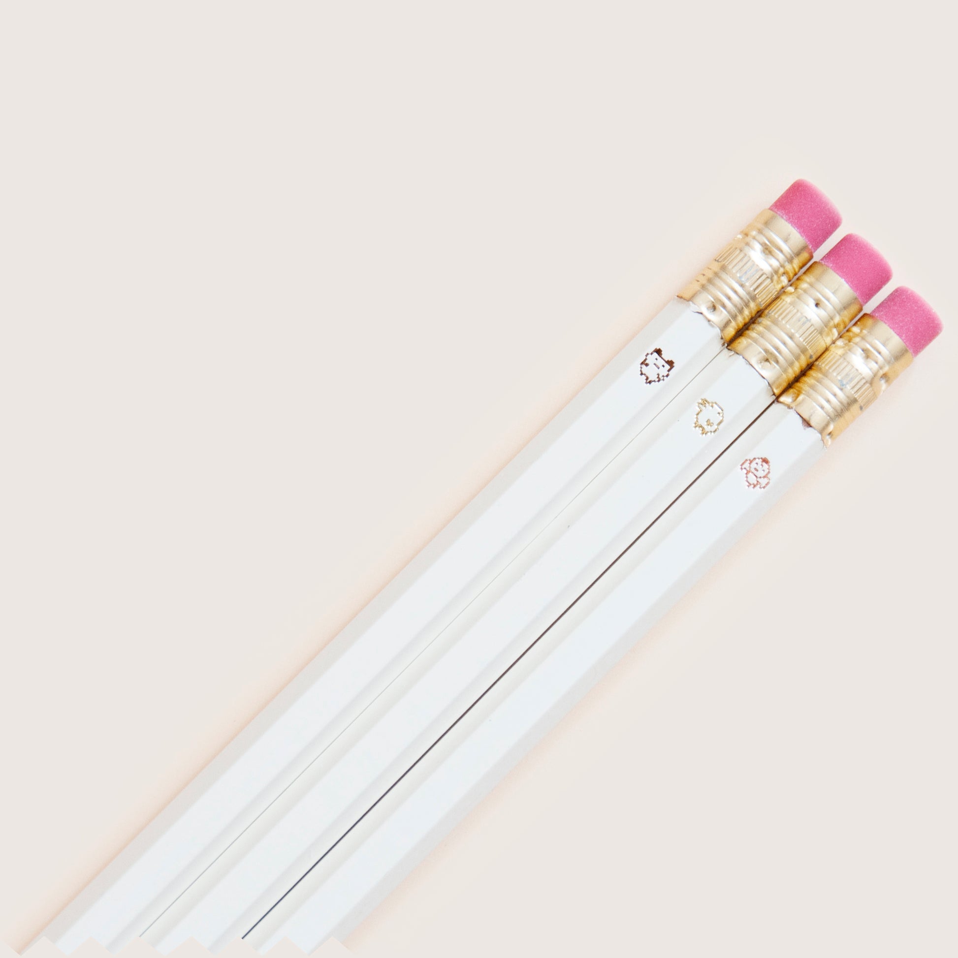 Original 90s Tamagotchi inspired pencil set featuring tiny pixel sprites, hand-stamped on wooden pencils, neutral shades