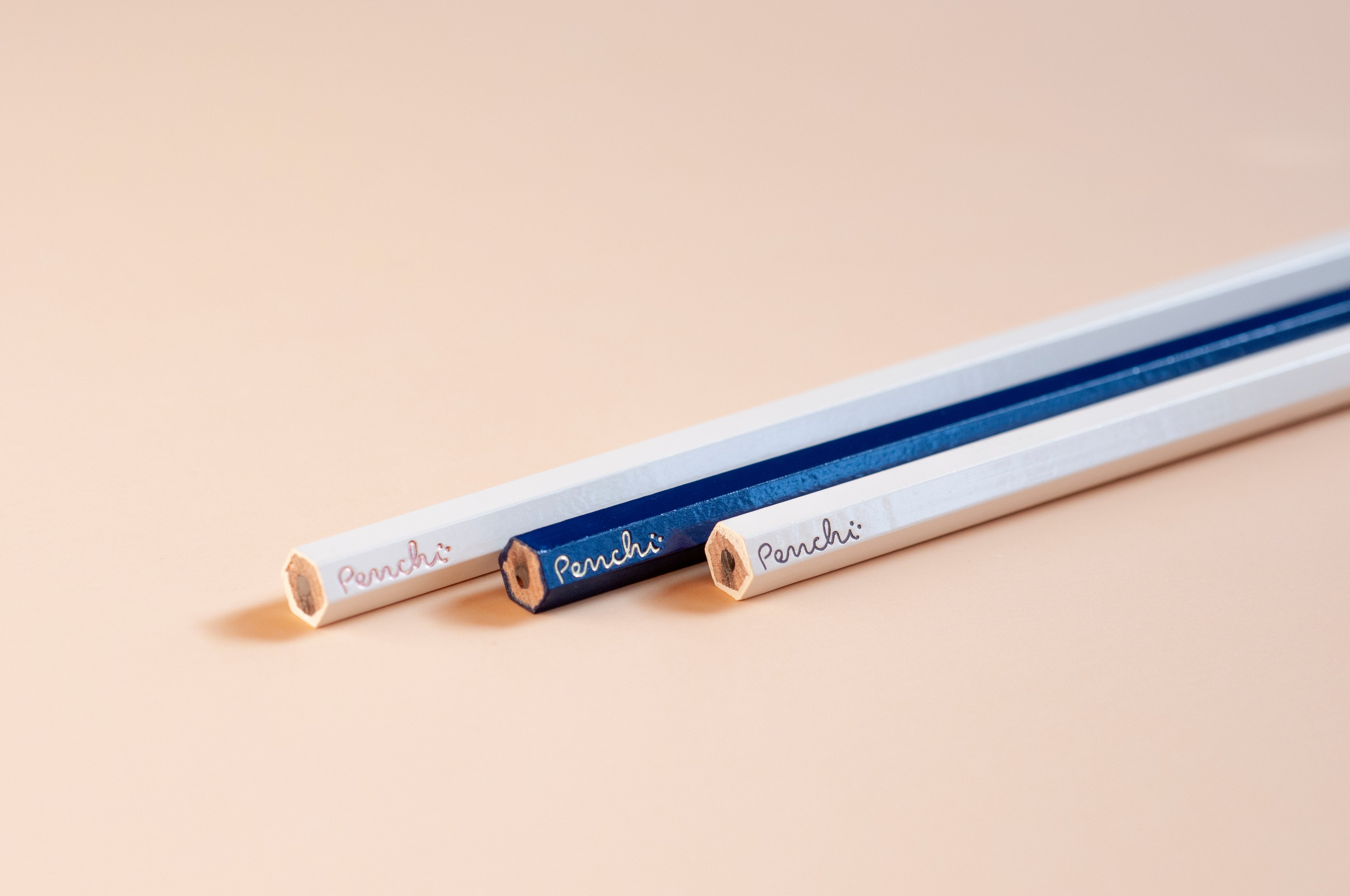 Wooden hexagonal pencils featuring the Penchi logo on the tip ends