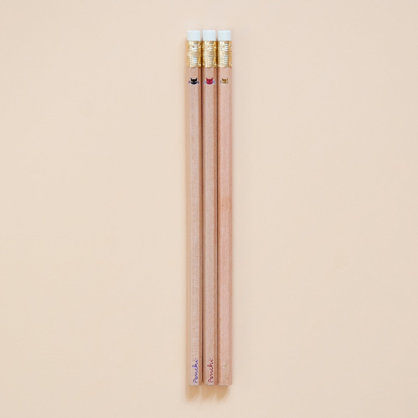 Cute tiny minimalist shiny metallic kitty cat faces, stamped by hand on natural wood pencils using hot metallic foils