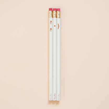 Creative face pencil set. Happy on the front and sad on the back. Hand-stamped using metallic hot-foils on wooden hexagonal pencils, ivory and copper